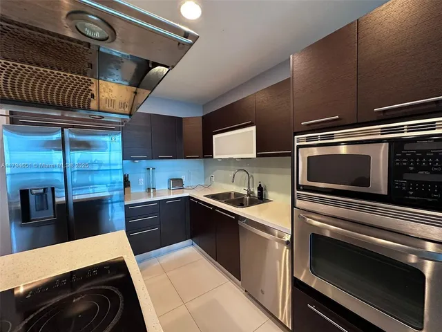 a kitchen with a sink stove and microwave