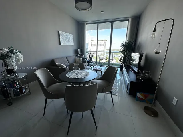 a view of a dining room with furniture and window