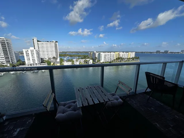 a view of a chairs and table in a balcony