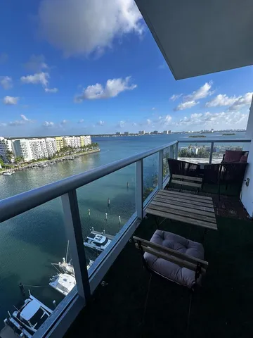 a view of a balcony with furniture