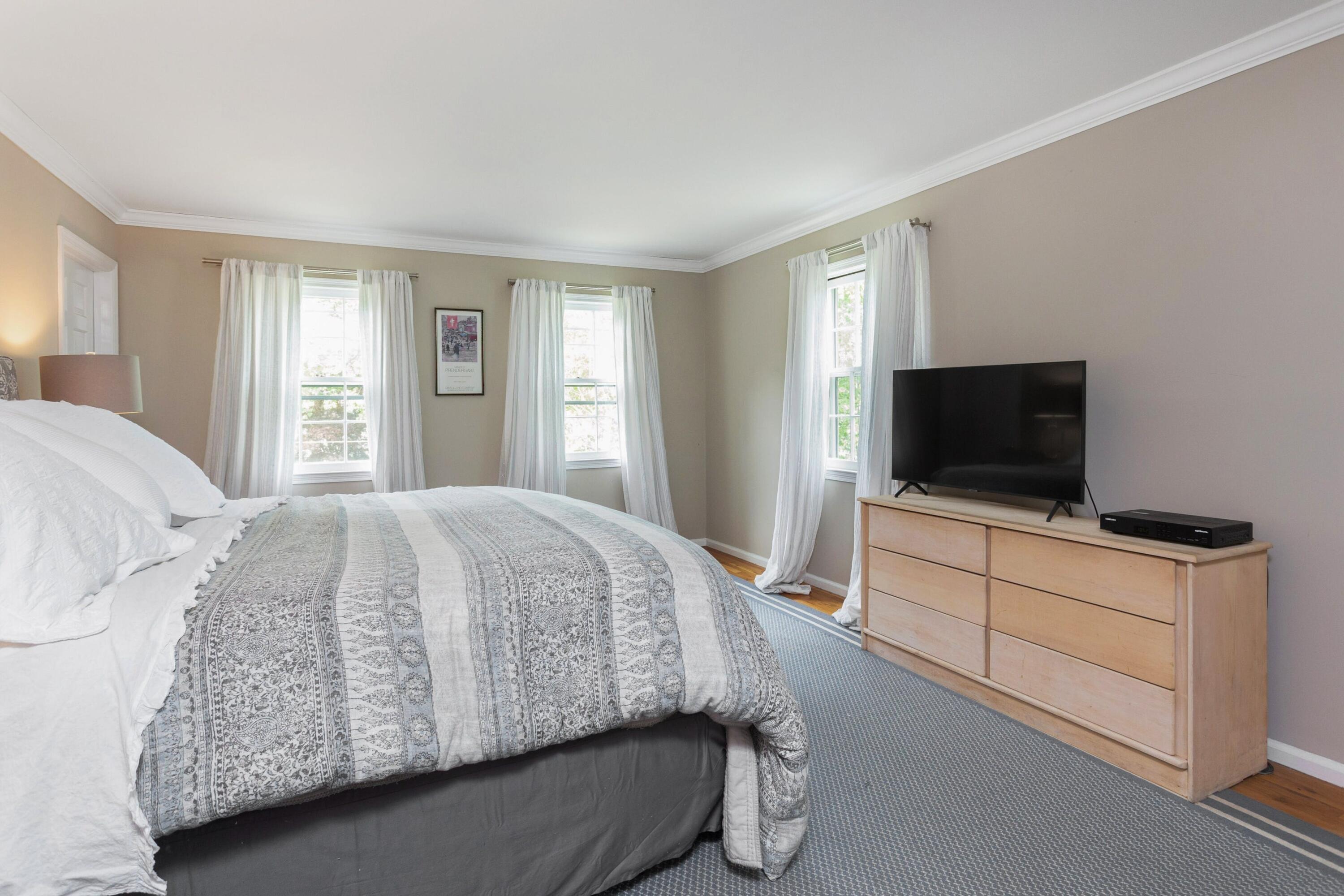 29 Country Club Road Darien, CT 06820 - Photo 23 of 39 a bedroom with a bed and a flat screen tv