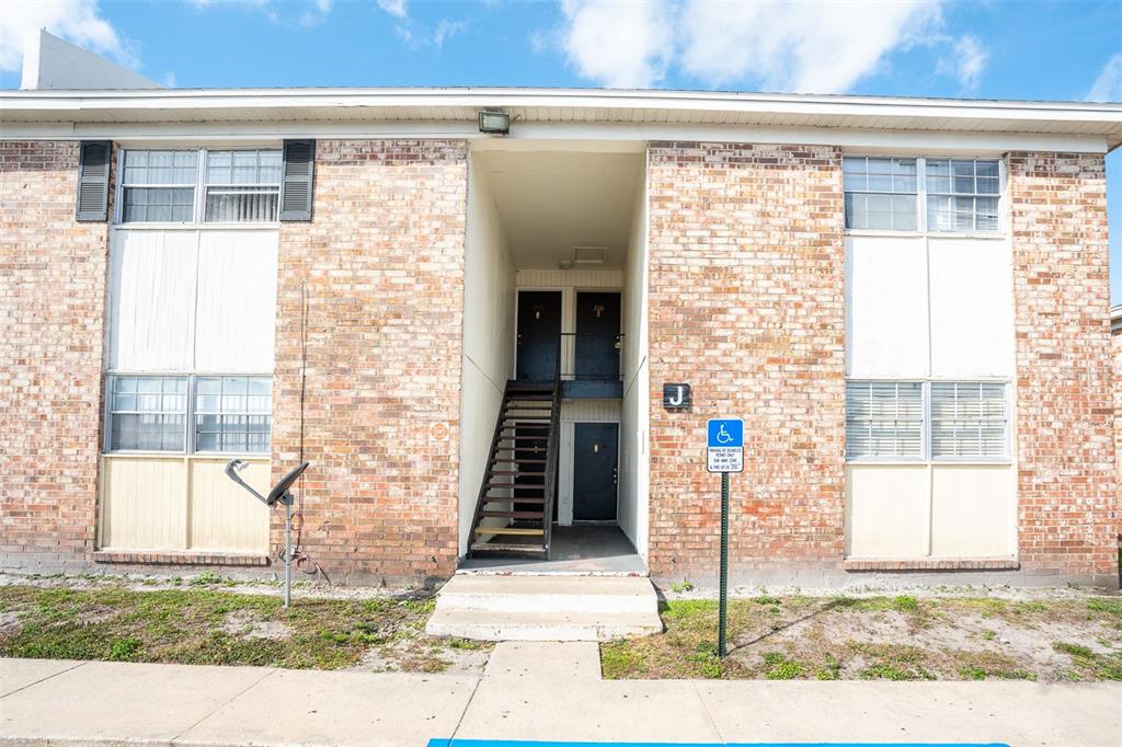 5317 Curry Ford Road, Unit J106 Orlando, FL 32812 - Photo 1 of 1 a front view of a house with a yard