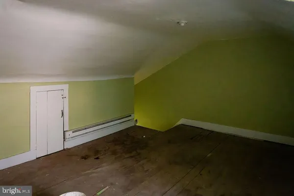 a room with a window and a wooden floor