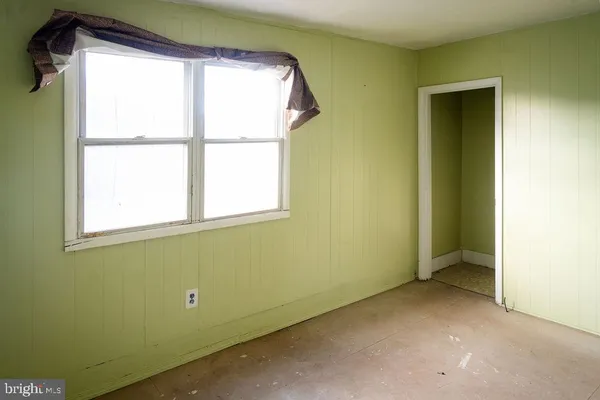 a view of walk in closet with clothes