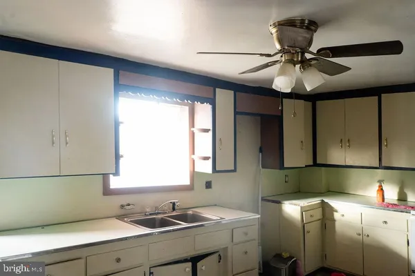 a kitchen with a sink cabinets and window