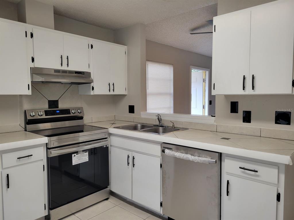 3133 Huron Avenue Oldsmar, FL 34677 - Photo 15 of 43 a kitchen with a sink stove and cabinets