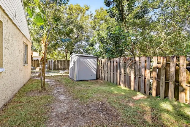 a backyard of a house with table and chairs