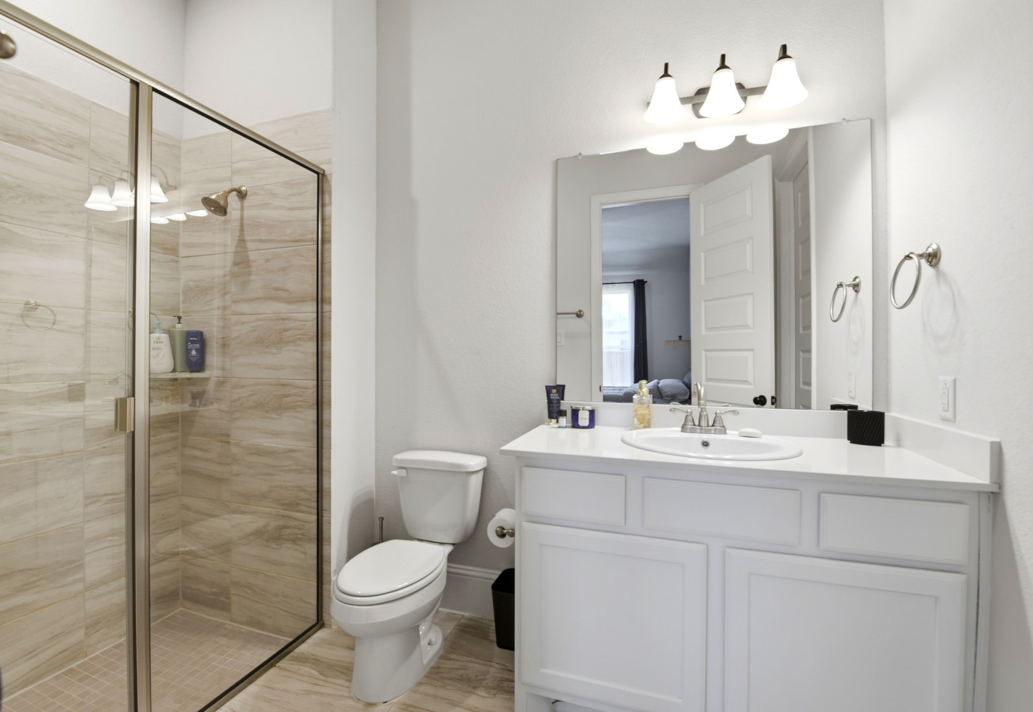 10062 South Goshawk Trail Conroe, TX 77385 - Photo 29 of 43 a bathroom with a toilet sink and shower