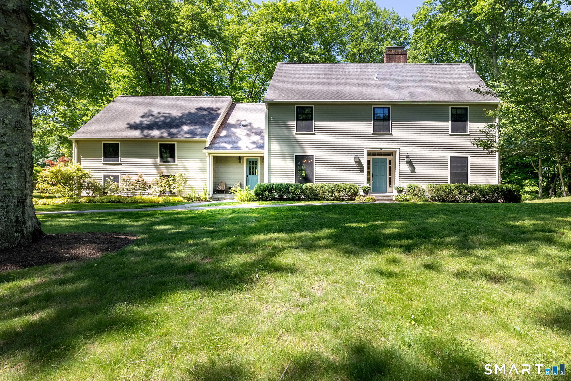33 Hunter Lane Ridgefield, CT 06877 - Photo 1 of 39 a front view of a house with a garden and trees