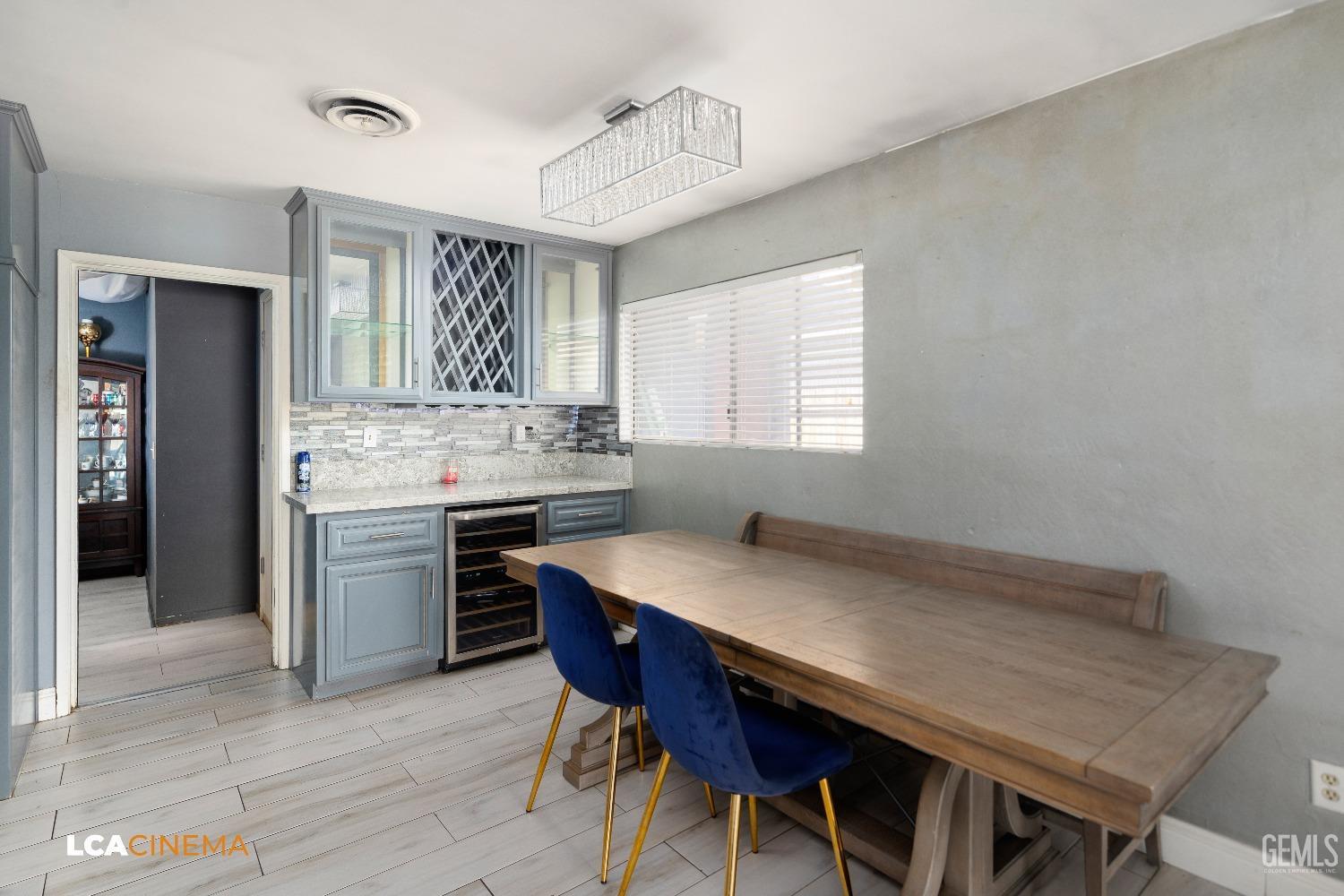 Undisclosed Address Bakersfield, CA 93306 - Photo 11 of 34 a kitchen with a table chairs sink and cabinets