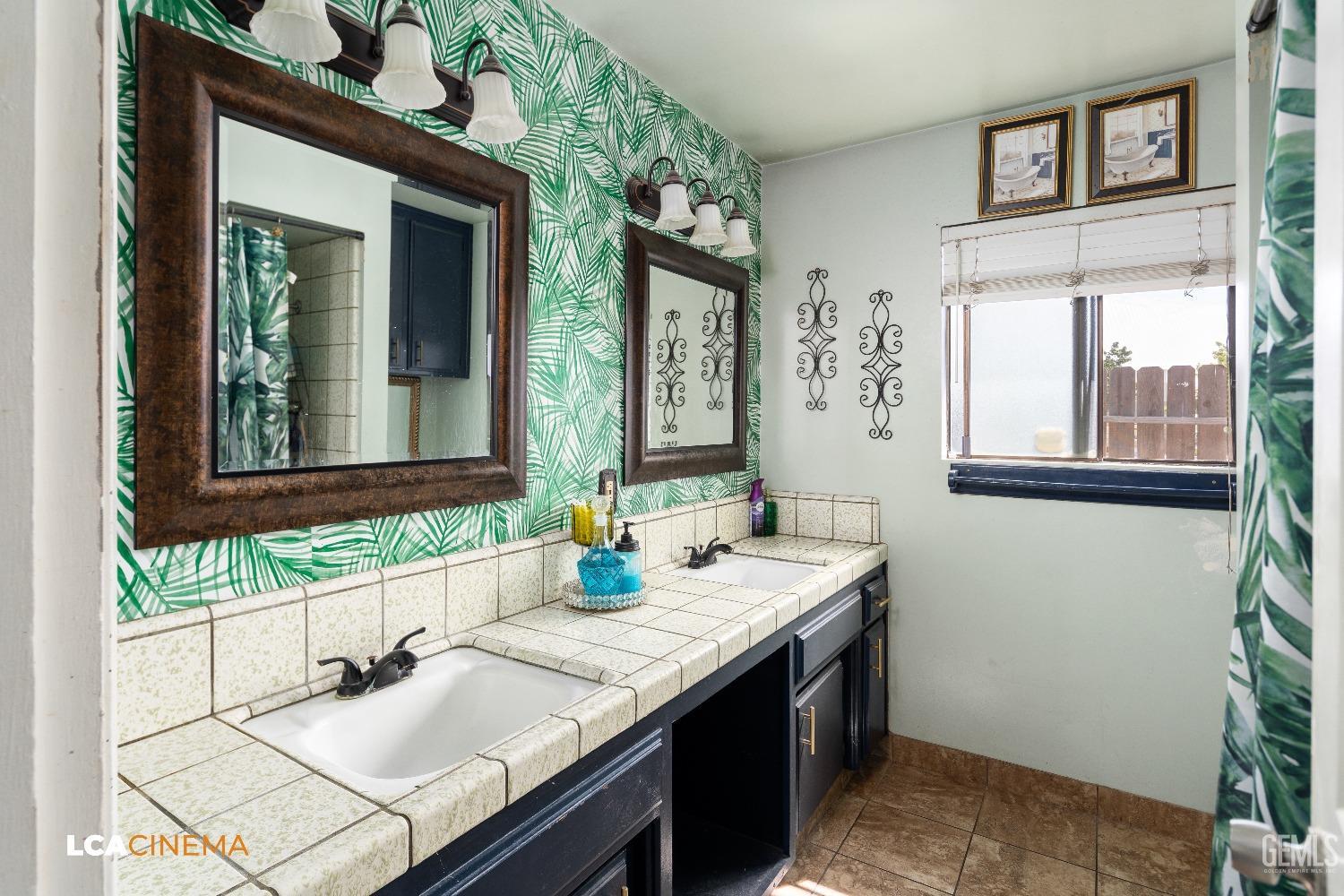 Undisclosed Address Bakersfield, CA 93306 - Photo 12 of 34 a bathroom with a granite countertop sink and a mirror