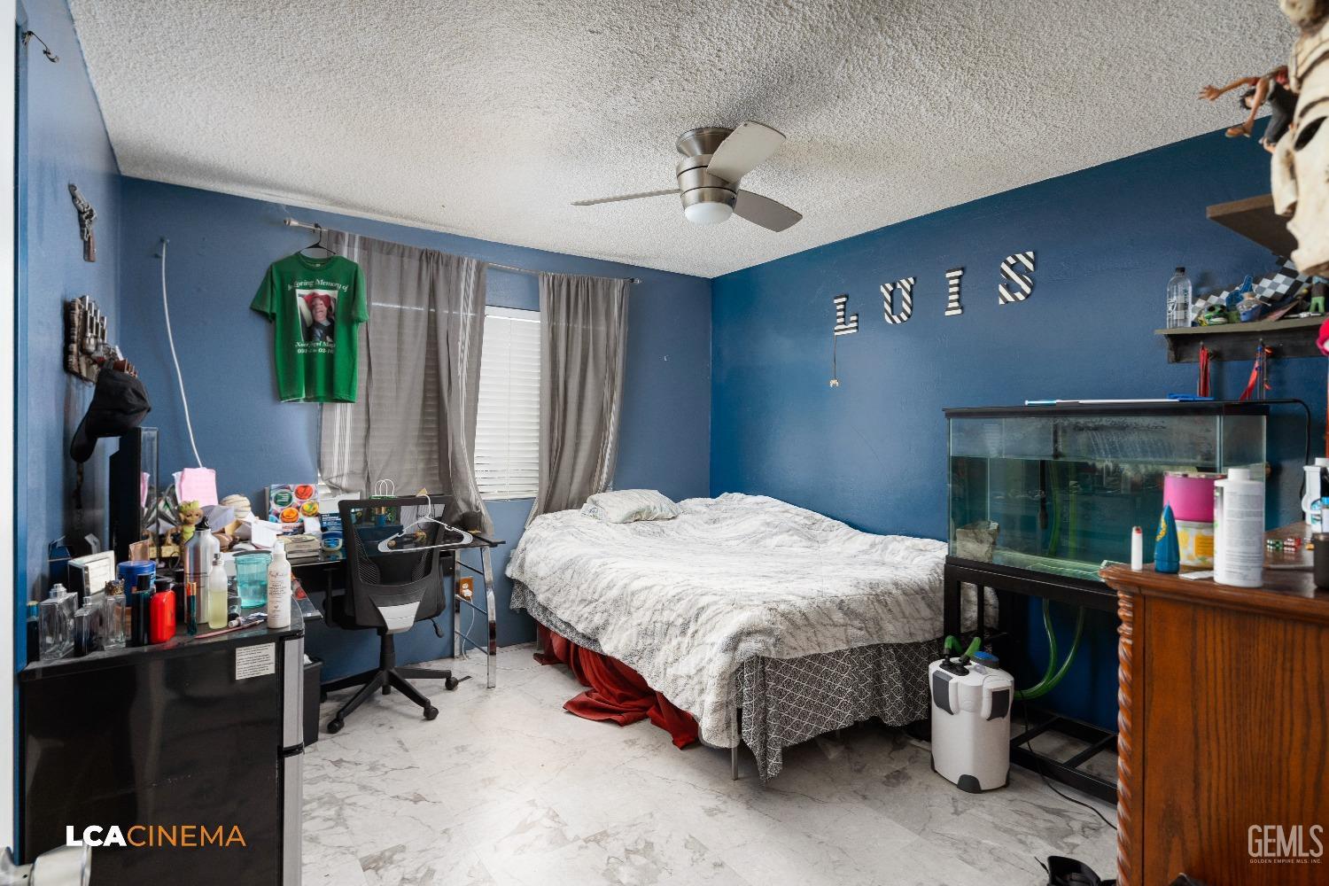 Undisclosed Address Bakersfield, CA 93306 - Photo 13 of 34 a bed room with a bed and a chandelier