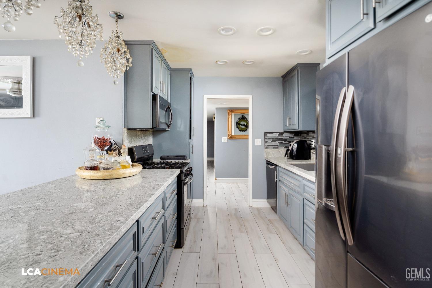 Undisclosed Address Bakersfield, CA 93306 - Photo 9 of 34 a kitchen with stainless steel appliances granite countertop a refrigerator a stove and a sink