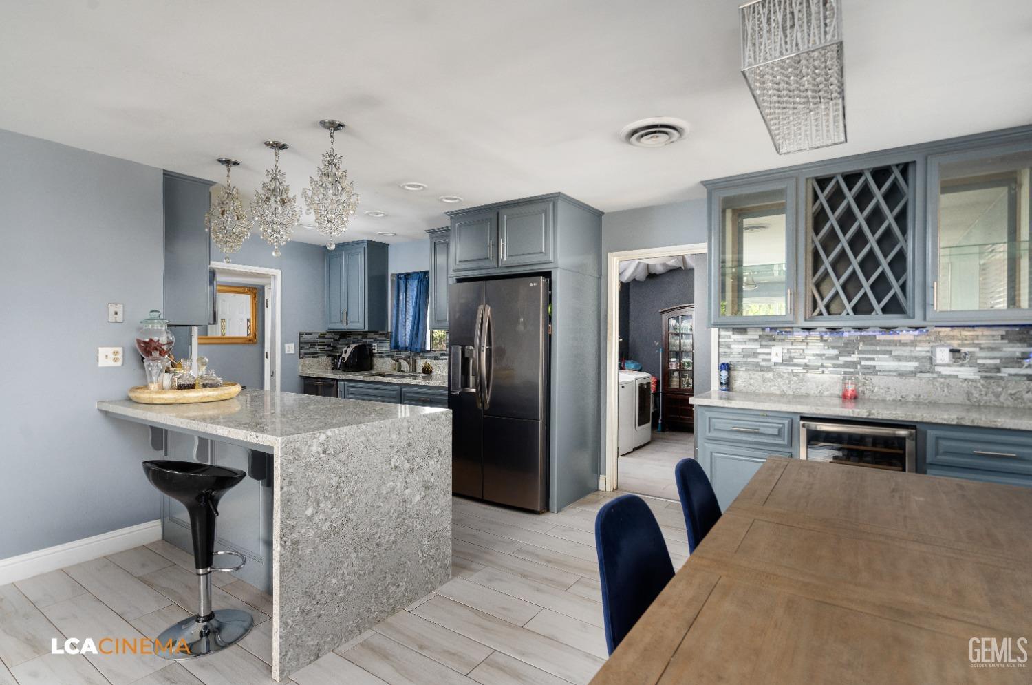 Undisclosed Address Bakersfield, CA 93306 - Photo 10 of 34 a kitchen with granite countertop cabinets and stainless steel appliances