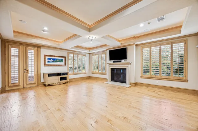 a view of an empty room with a fireplace and a window