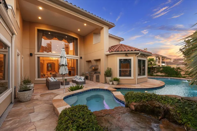 a front view of a house with garden and patio