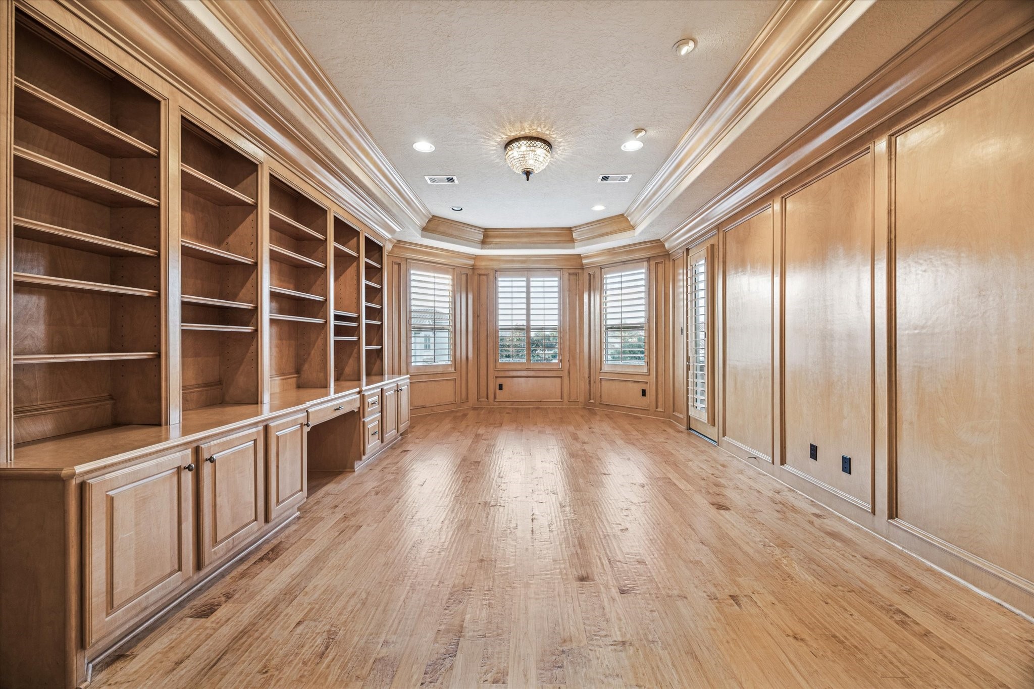 13907 Slate Creek Lane Houston, TX 77077 - Photo 21 of 29 a view of an empty room with wooden floor and windows