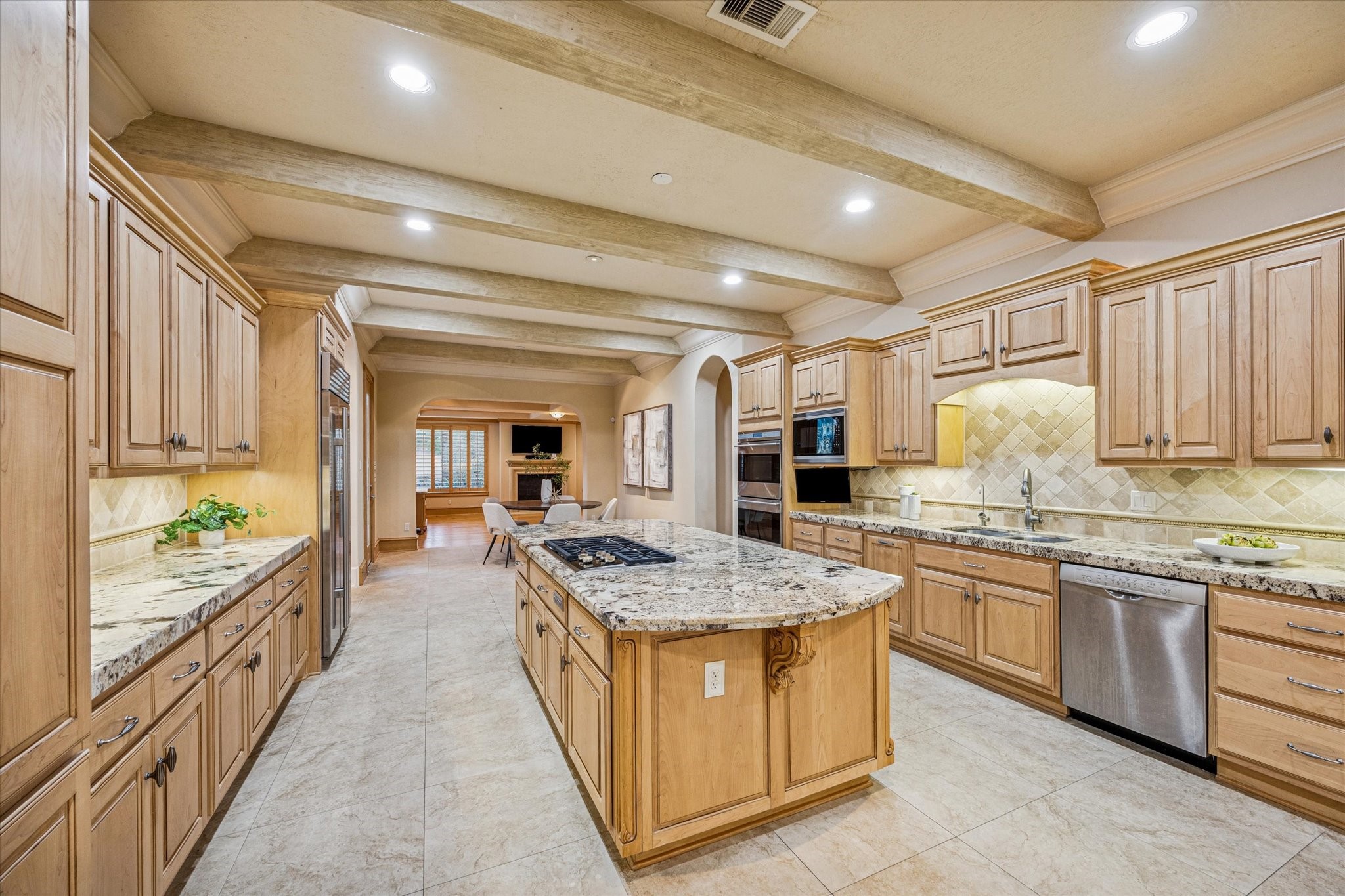 13907 Slate Creek Lane Houston, TX 77077 - Photo 10 of 29 a large kitchen with kitchen island a sink stove and cabinets