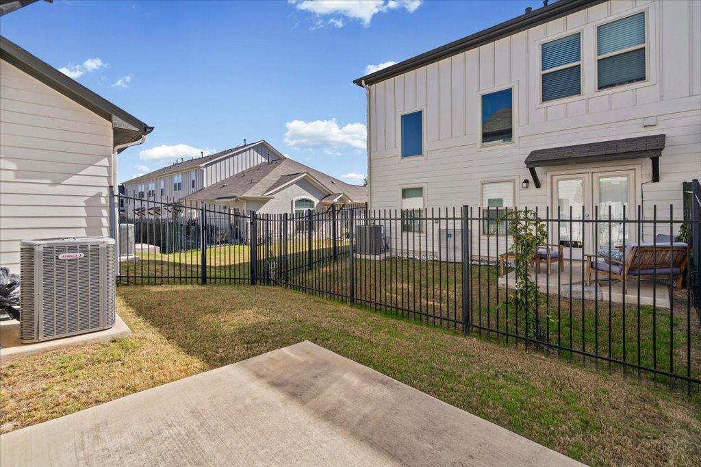 1609 Catalan Road, Unit 1802 Austin, TX 78748 - Photo 11 of 25 Fenced backyard with a patio and a residential view