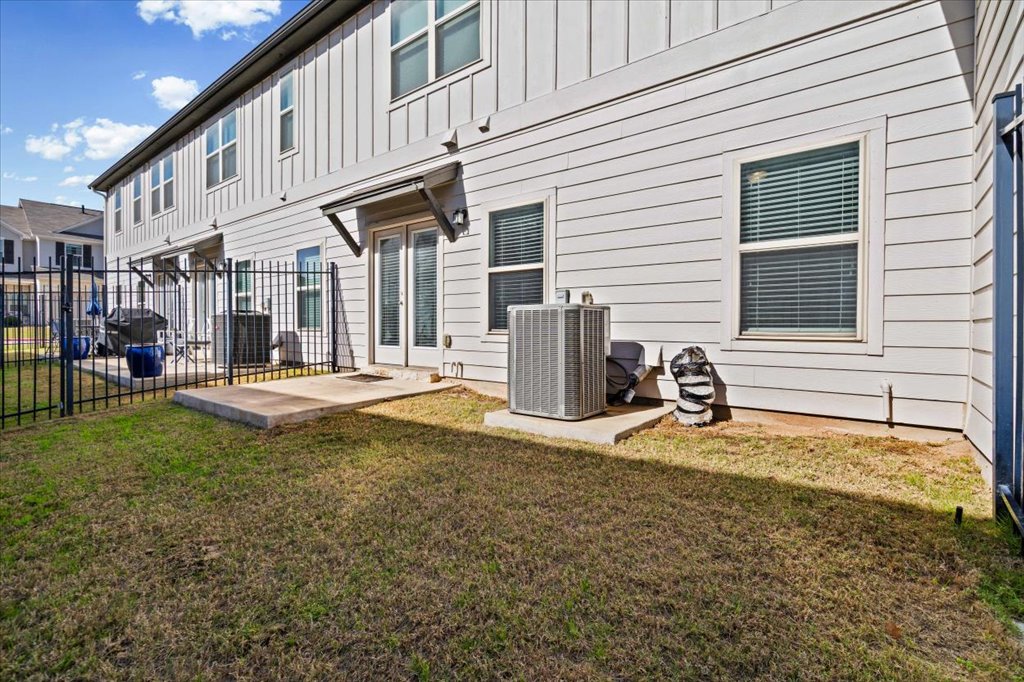 1609 Catalan Road, Unit 1802 Austin, TX 78748 - Photo 12 of 25 Rear view of property with board and batten siding and a patio