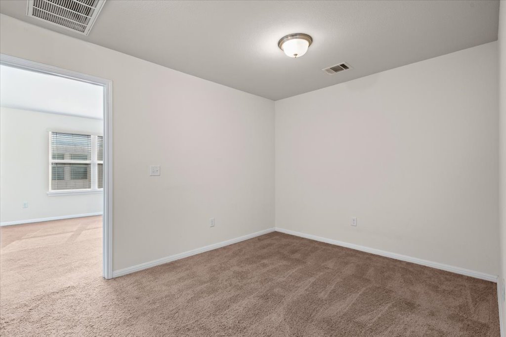 1609 Catalan Road, Unit 1802 Austin, TX 78748 - Photo 13 of 25 Spare room featuring light colored carpet