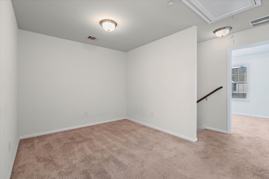 1609 Catalan Road, Unit 1802 Austin, TX 78748 - Photo 14 of 25 Empty room featuring attic access and light colored carpet