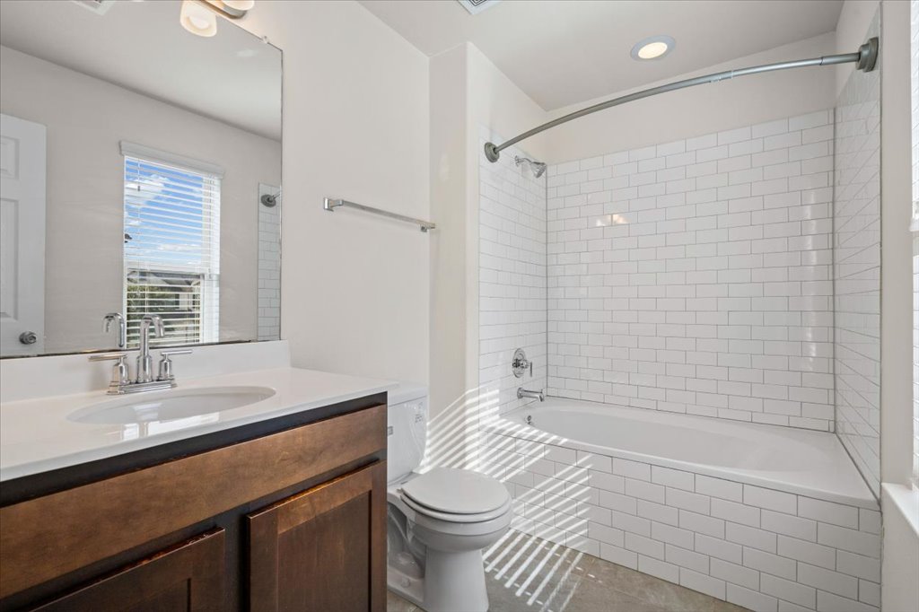 1609 Catalan Road, Unit 1802 Austin, TX 78748 - Photo 18 of 25 Bathroom featuring vanity, tiled shower / bath, tile patterned floors, and recessed lighting