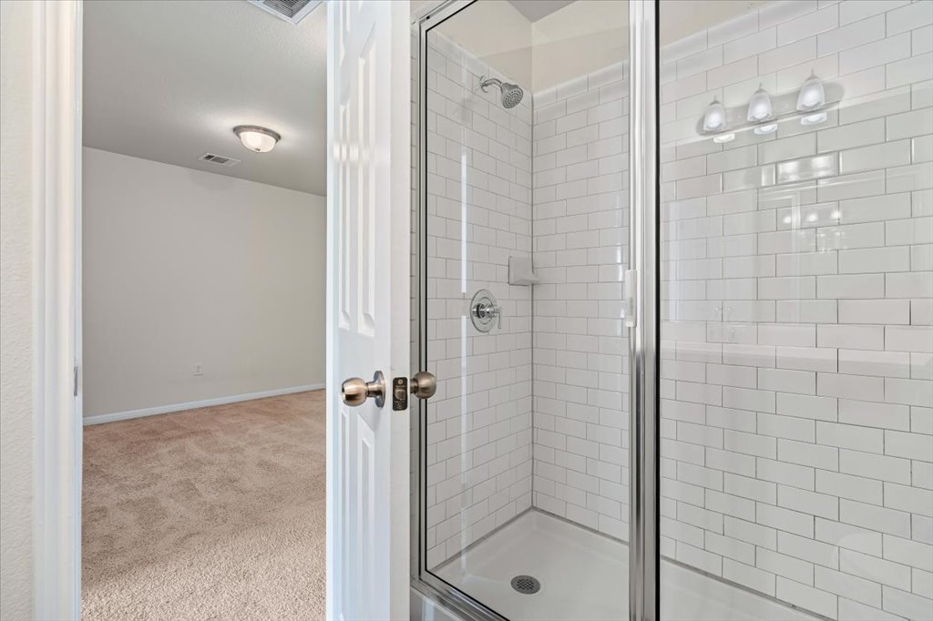 1609 Catalan Road, Unit 1802 Austin, TX 78748 - Photo 22 of 25 Bathroom featuring a stall shower and light carpet