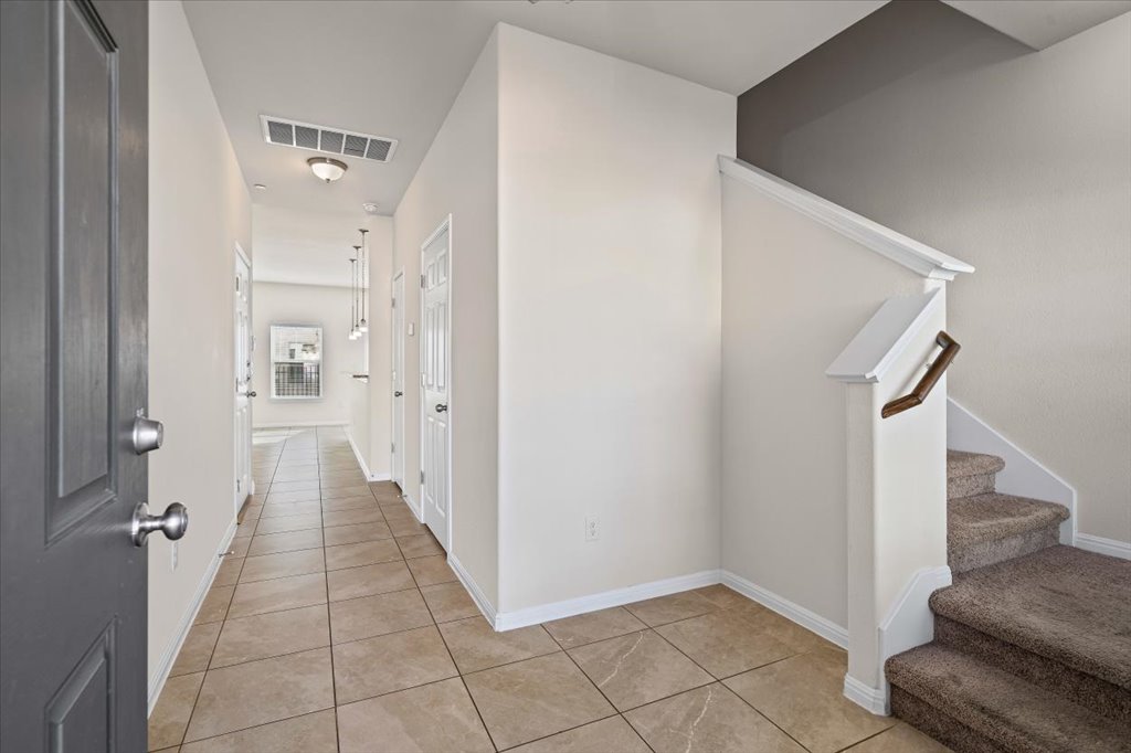 1609 Catalan Road, Unit 1802 Austin, TX 78748 - Photo 3 of 25 Corridor featuring stairway and light tile patterned floors