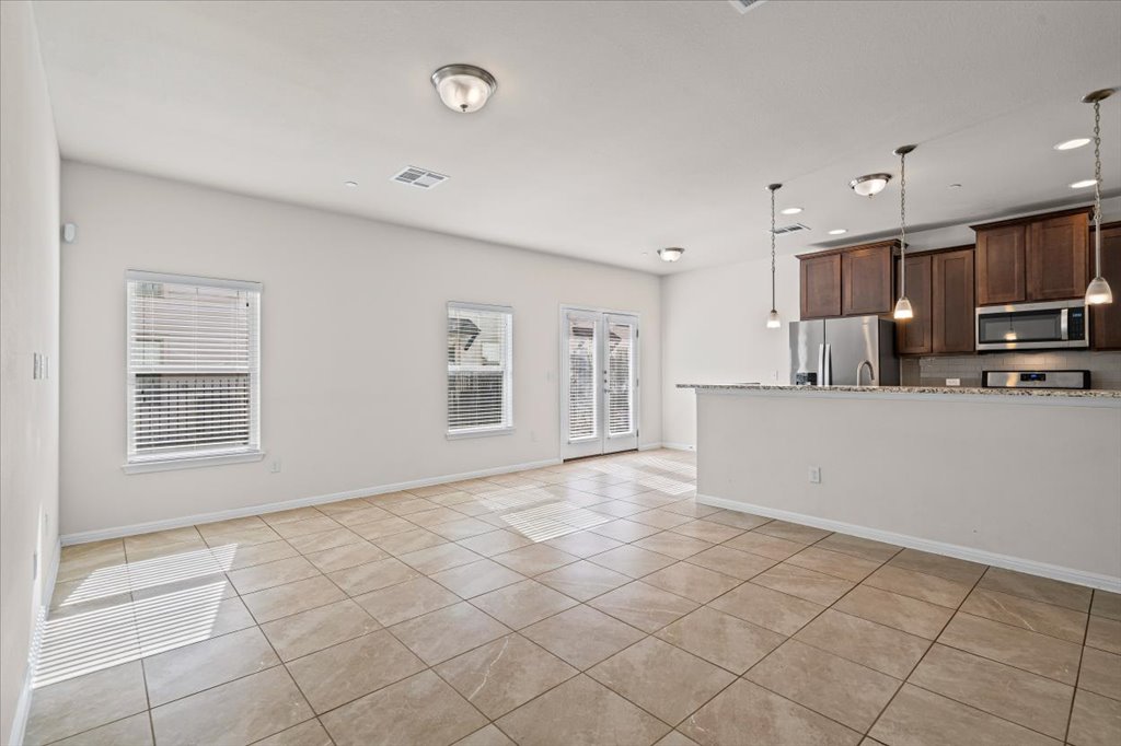 1609 Catalan Road, Unit 1802 Austin, TX 78748 - Photo 25 of 25 Kitchen with dark brown cabinets, open floor plan, hanging light fixtures, stainless steel appliances, and recessed lighting