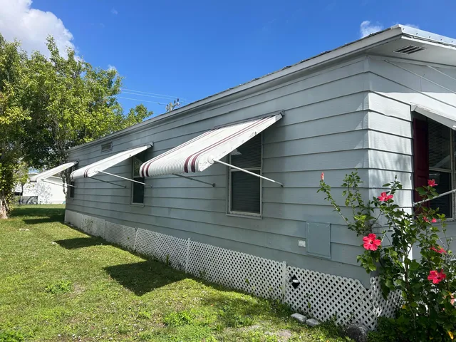 a view of a house with swimming pool and sitting area