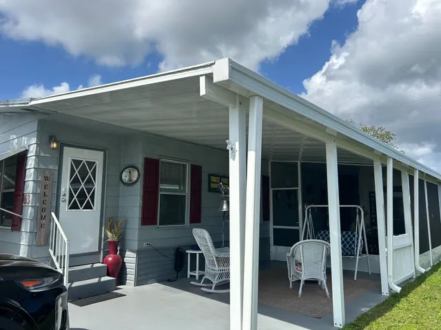 a view of a house with backyard and porch