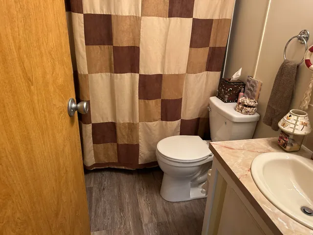 a bathroom with a sink mirror and toilet