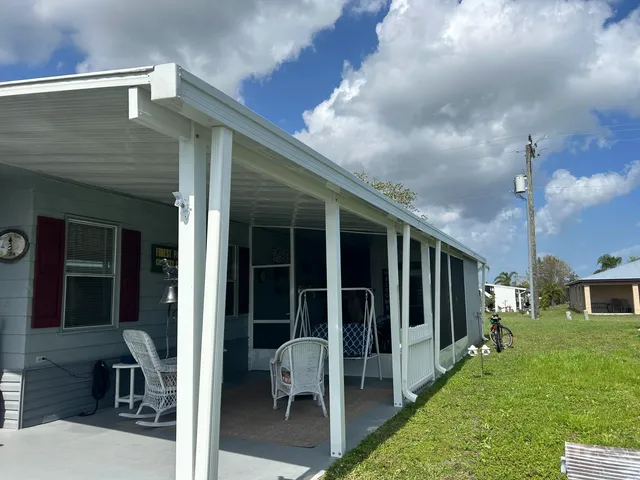 a backyard of a house with table and chairs