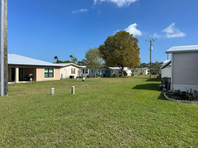 a view of house with a yard