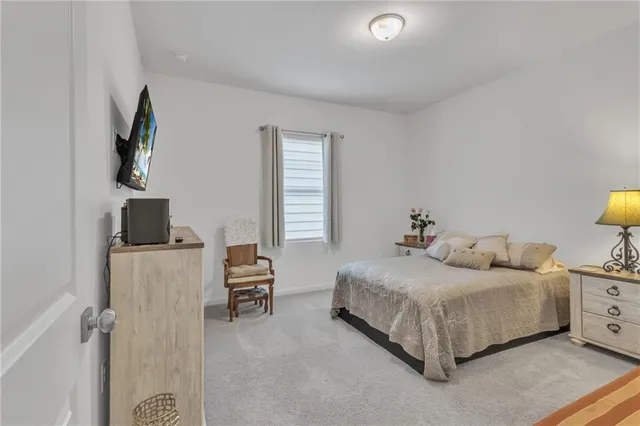 a living room with furniture and a dining table with kitchen view