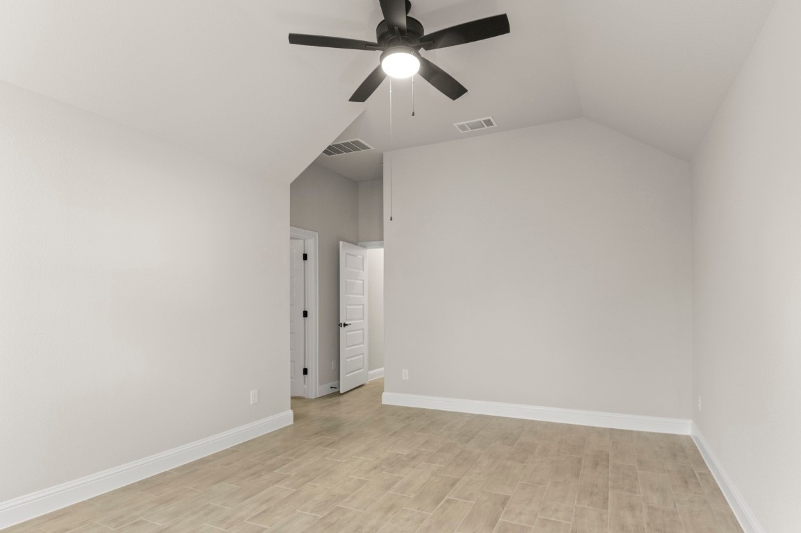 2605 Sam Bass Road, Unit 65 Round Rock, TX 78681 - Photo 24 of 33 an empty room with closet and a chandelier fan