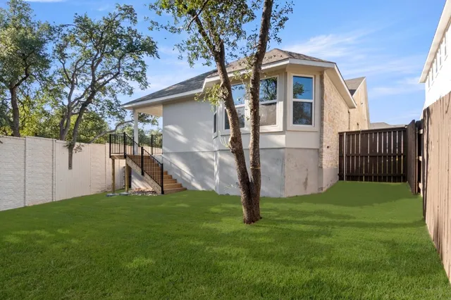 a view of a backyard with a tree