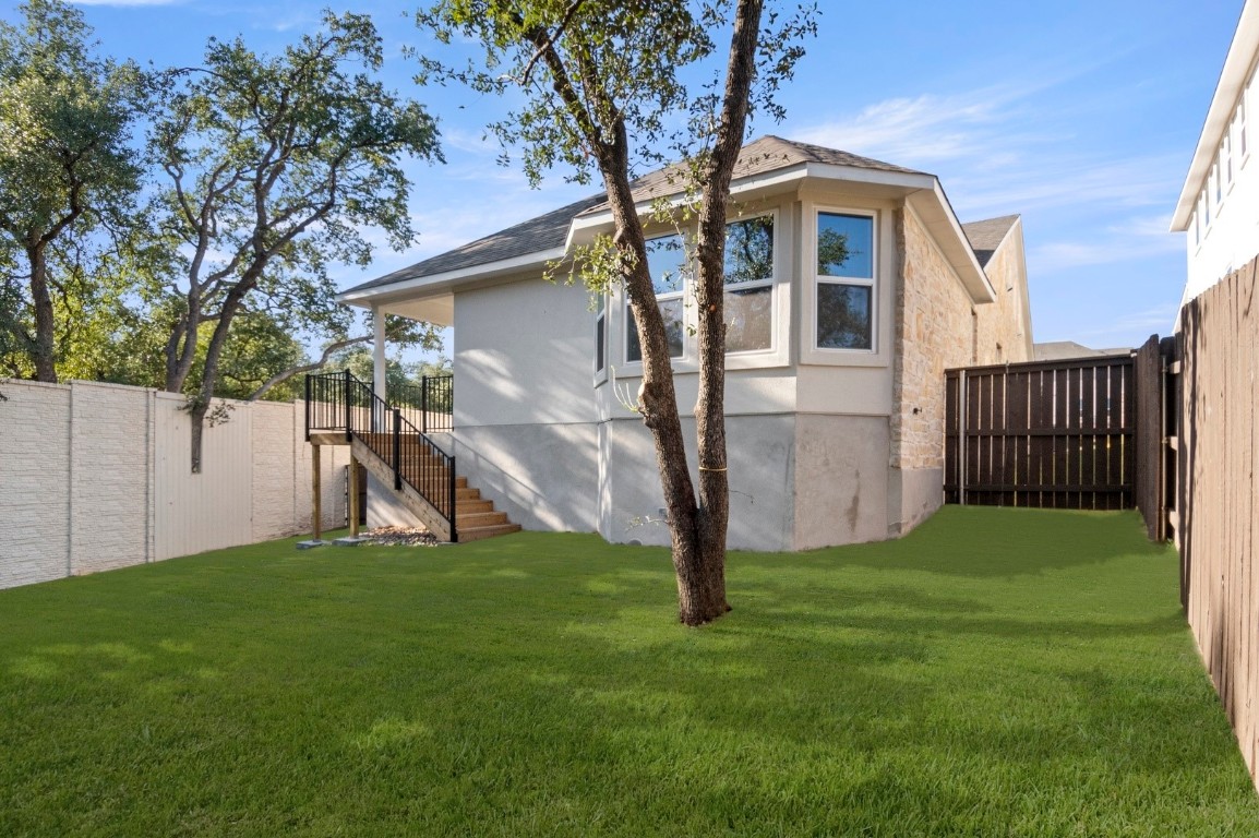2605 Sam Bass Road, Unit 65 Round Rock, TX 78681 - Photo 32 of 33 a view of a backyard with a tree