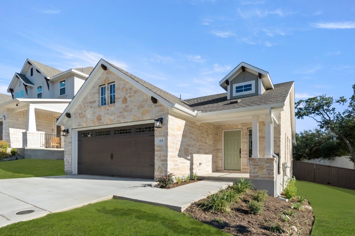 2605 Sam Bass Road, Unit 65 Round Rock, TX 78681 - Photo 5 of 33 a front view of a house with a yard and garage