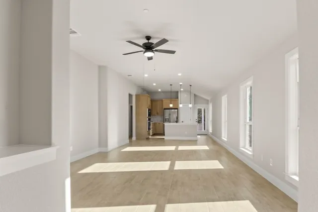 a view of a living room with a ceiling fan