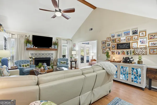 a living room with furniture a flat screen tv and a fireplace