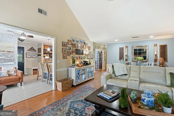 a living room with furniture and a wooden floor