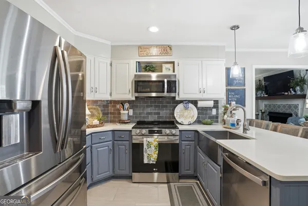 a kitchen with stainless steel appliances granite countertop a stove a sink and a refrigerator