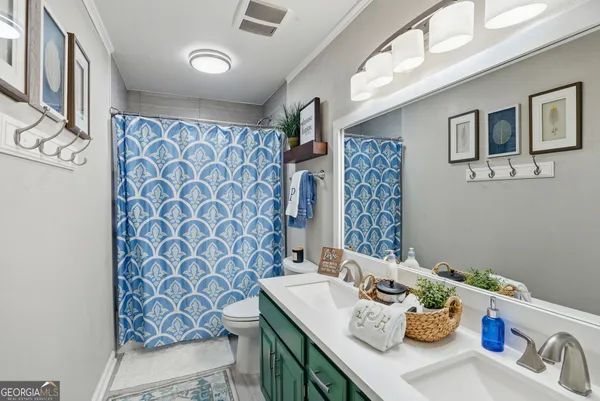 a bathroom with a sink a mirror and shower