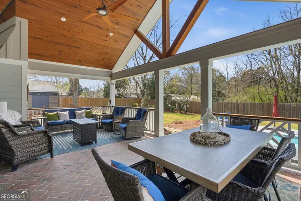 a living room with furniture a large window and a table