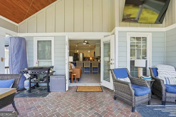 a view of living room filled with furniture and large windows