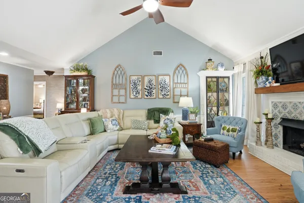 a living room with furniture fireplace and flat screen tv