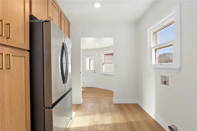 a view of a hallway with granite countertop a refrigerator