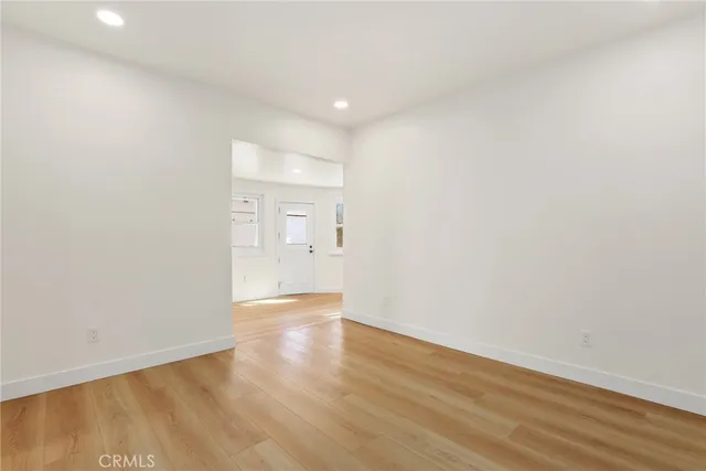 a view of an empty room and wooden floor